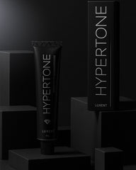 Tinte capilar profesional Hypertone de Luxent en tubo y caja sobre fondo oscuro - Luxent Professional